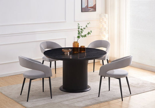 Elevate your dining room with the Jordan 5PC Dining Set Grey, featuring a sleek round table and plush grey velvet chairs for modern elegance and comfort.
