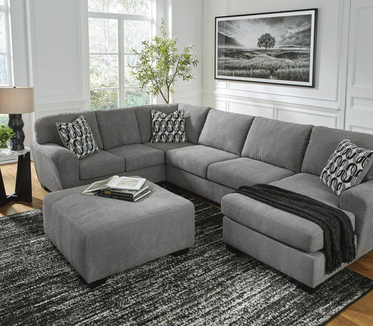 Ashley 324-02 sectional with ottoman from Moda Home Furniture, featuring modern gray upholstery and plush cushions, ideal for lounging and entertaining guests.