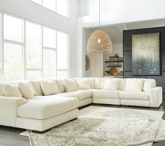 Experience luxury with the Michelle Ivory Velvet Curved Sectional. Plush deep seating, a graceful silhouette, and soft velvet upholstery for timeless elegance.