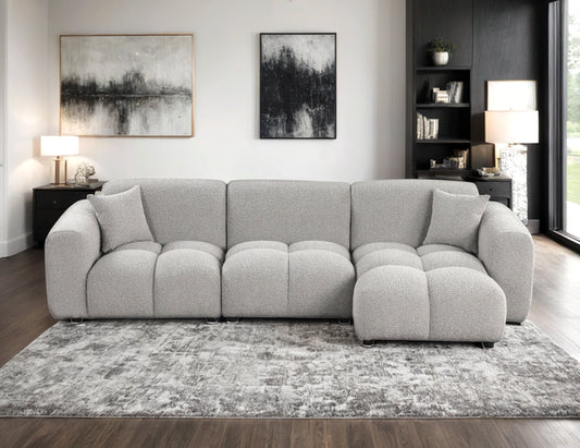 Spacious gray sectional with plush cushions & modern design. Shop now at Moda Home Furniture for cozy elegance in your living space.