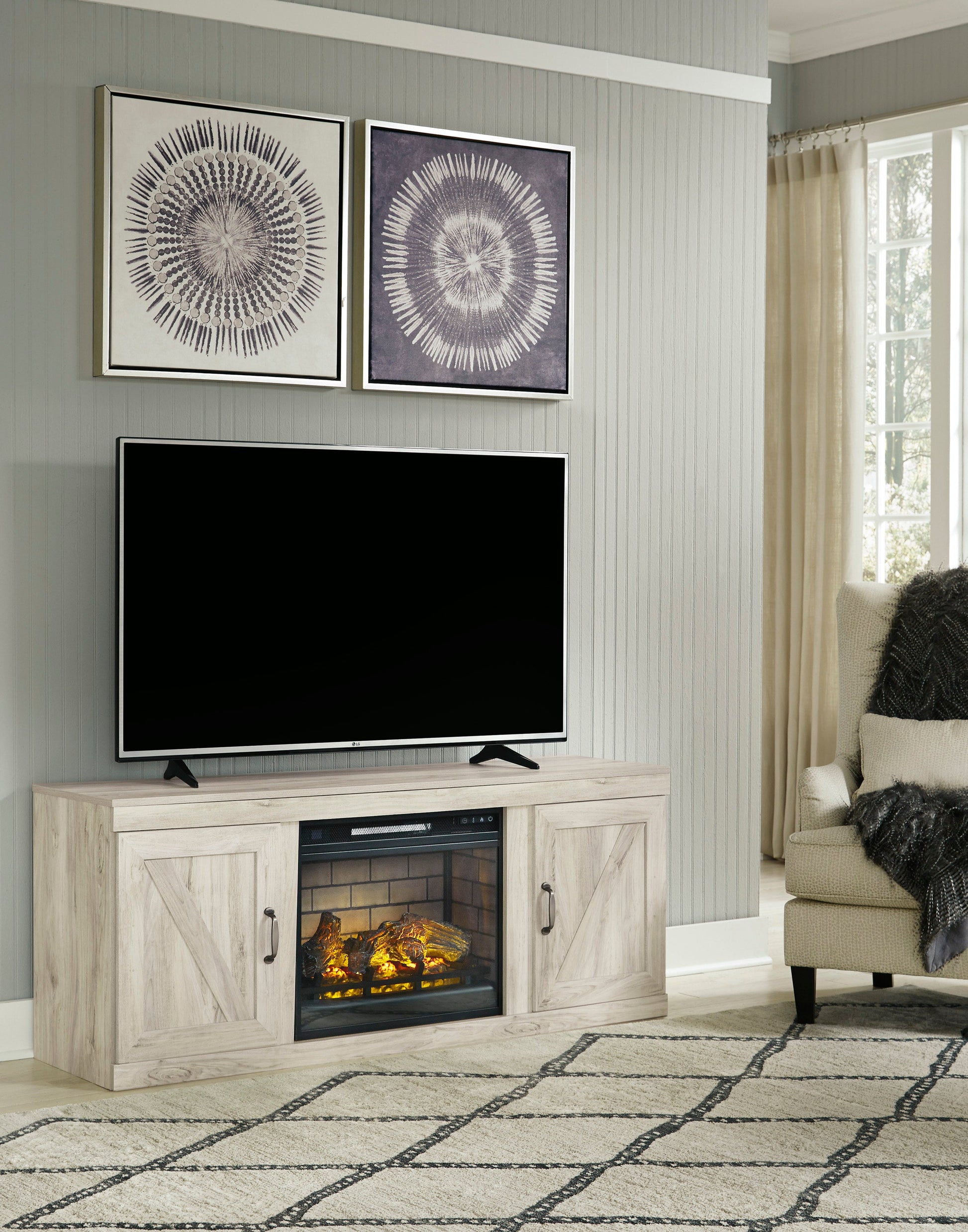 Brighten your space with the Bellaby White TV Stand from Moda Home Furniture. Solid wood design with cabinets and a cozy built-in fireplace.